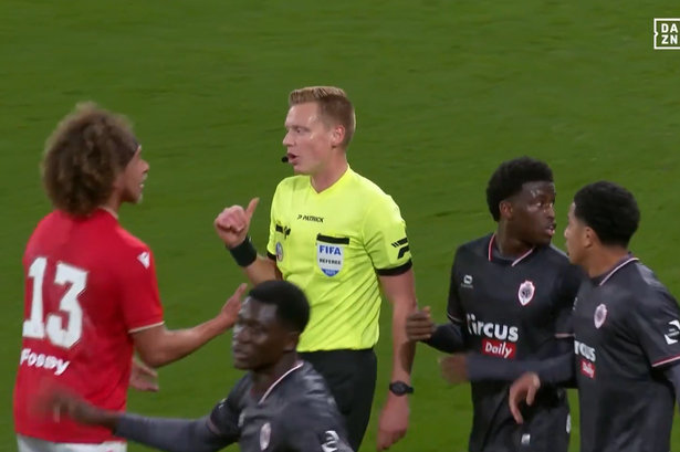 Standard Liege and Royal Antwerp players speak to the referee 
