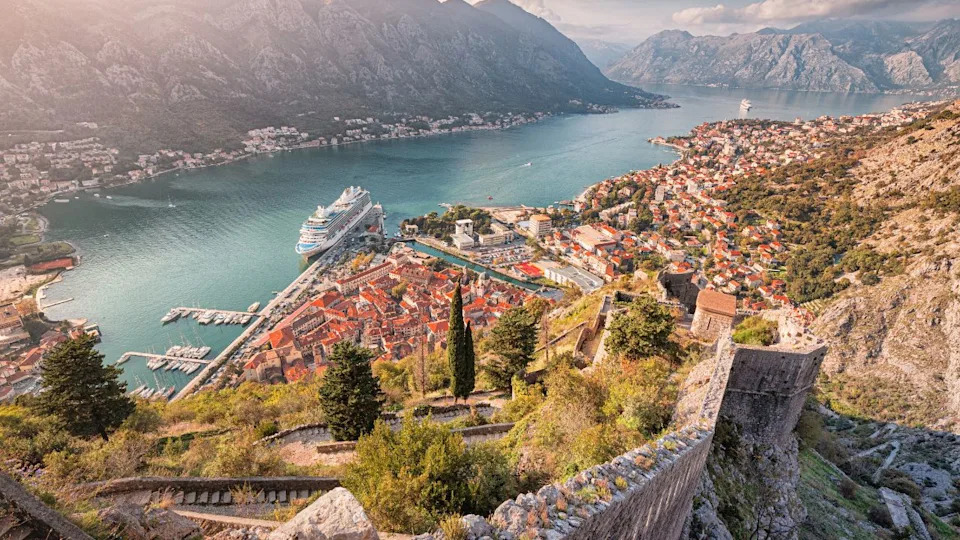 A stunning view of Kotor, Montenegro, with its historic fortress walls, Adriatic Sea, and charming old town nestled by the bay.