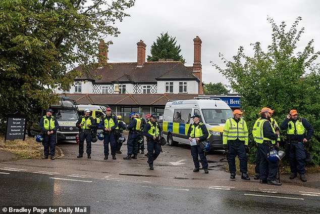 Thousands attended marches in the summer sparked after an asylum seeker living in the hotel wascharged - and later convicted - of sexually assaulting a teenage girl and a woman in Epping. Pictured: Police gathered outside the Bell Hotel