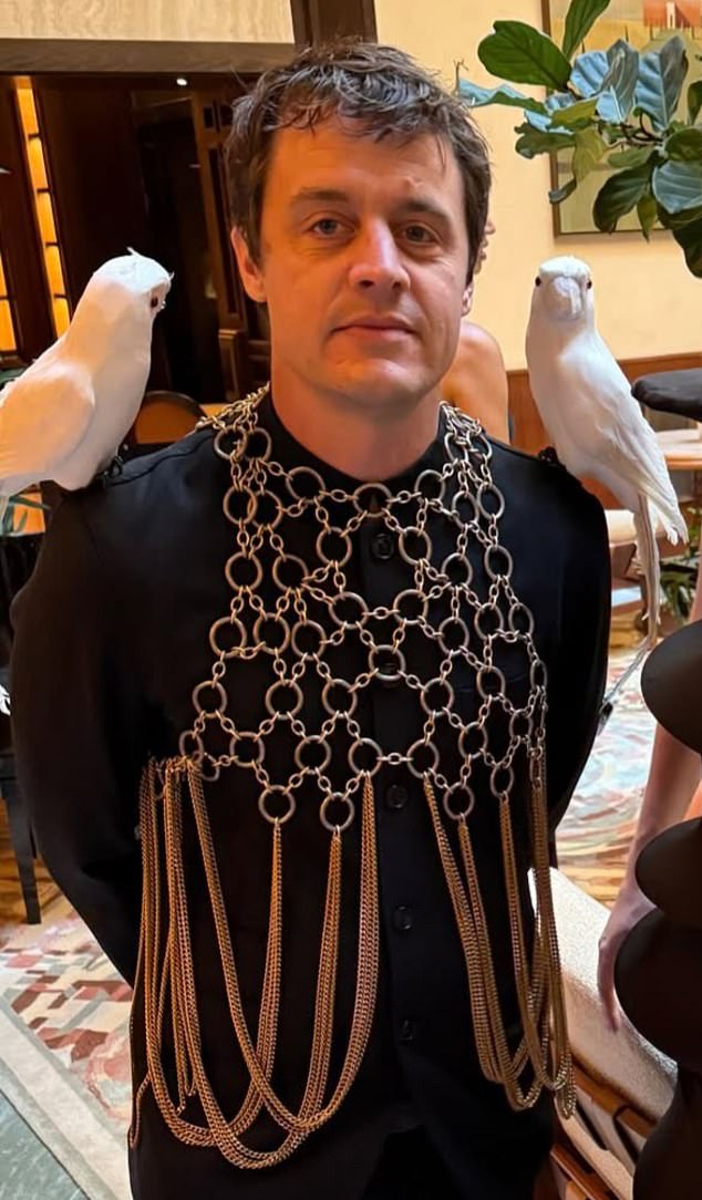 Filmmaker Oscar Boyson wore a black suit with chain-mail chest piece ¿ and a pair of obliging white cockatoos on his shoulders