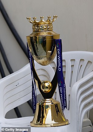 The trophy was pictured on plastic chairs at the venue