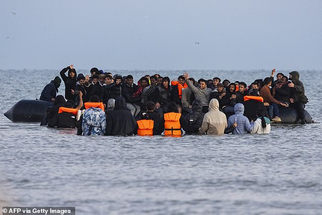 Migrants try to board a crowded smuggler's boat off the coast of northern France on September 19 in a bid to cross the English Channel