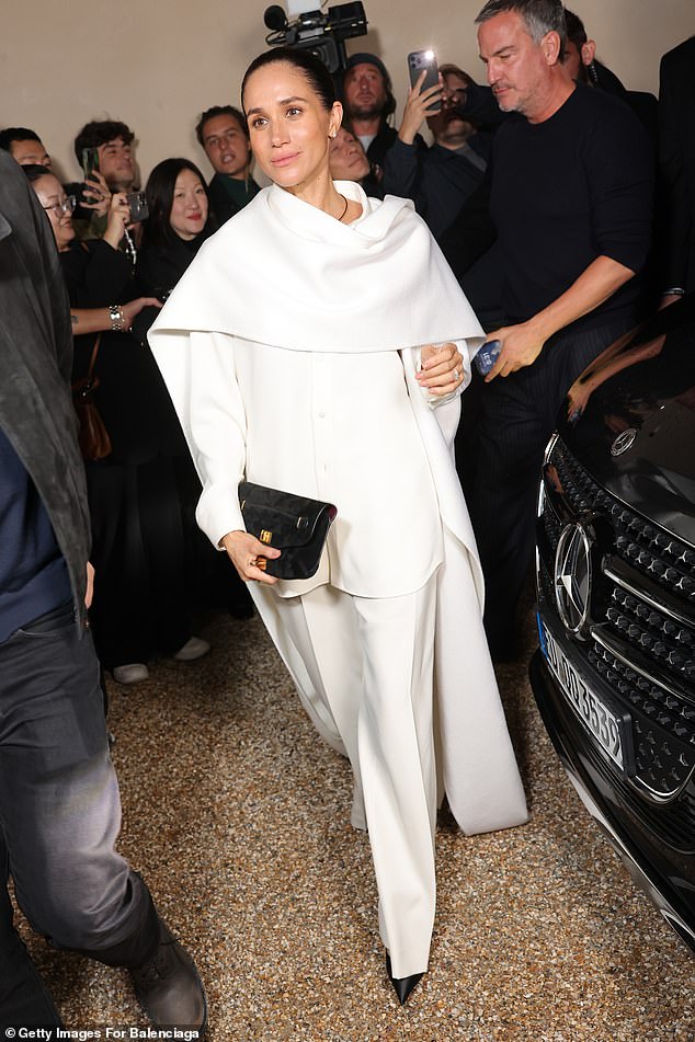Meghan turned up to the Balenciaga fashion show wearing one of Pierpaolo Piccioli's creations - a monstrous white shirt, cape and baggy trousers