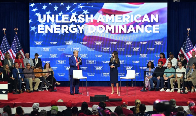 Pres. Trump in front of energy dominance sign