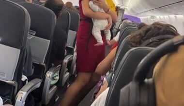A Virgin Australia flight attendant (pictured) helped a mother by holding her baby while she settled her other children