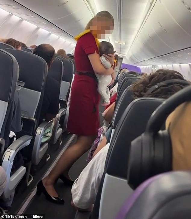 Some commenters were concerned the flight attendant (pictured) would get in trouble for the act while others praised her for going 'above and beyond' to help customers
