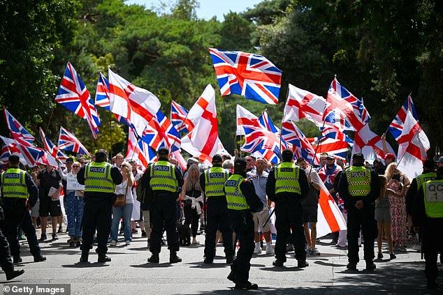 Asylum seekers are currently staying at two other hotels in the city (pictured, anti-migrant protesters on a march to one of the hotels on September 20, 2025)
