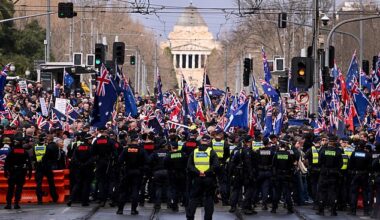 Police officers separate anti-immigration and pro-immigration protesters during a rally in Brisbane on August 31