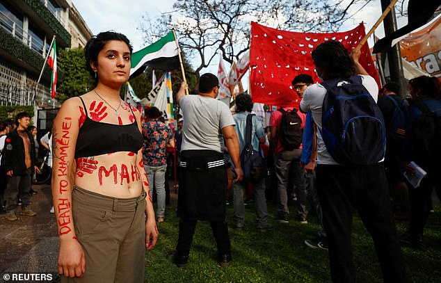A demonstrator takes part in a protest following the death of Mahsa Amini, in front of the Iranian embassy in Buenos Aires, Argentina, September 27, 2022