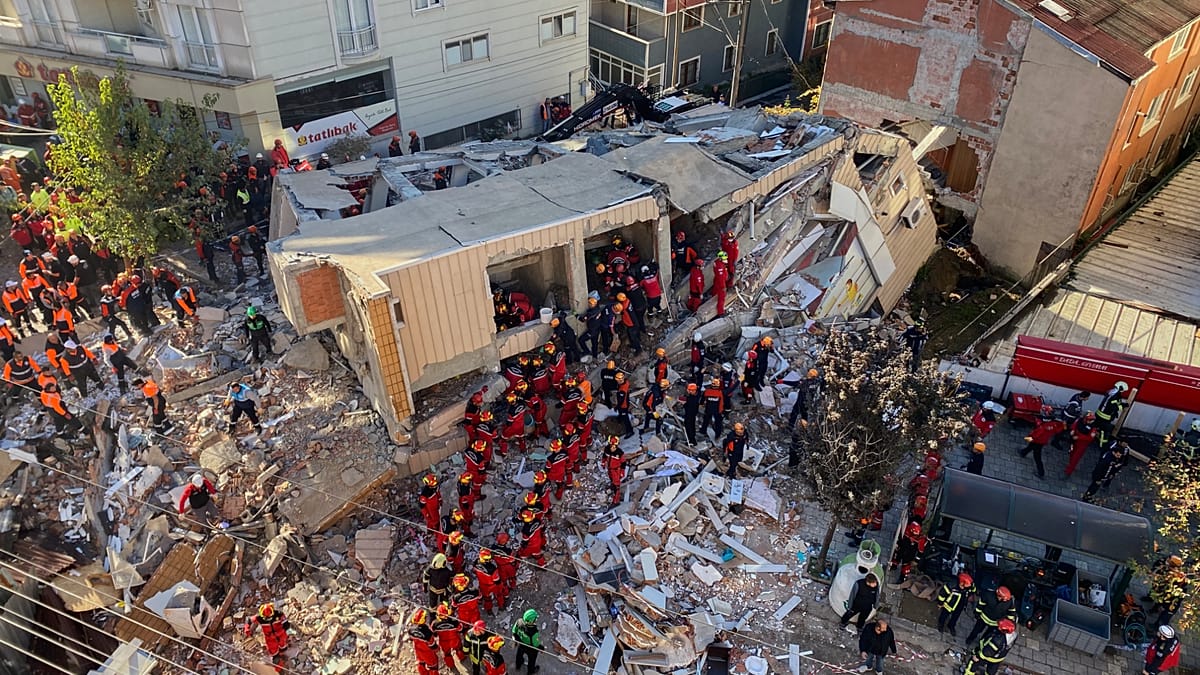Family trapped under rubble after seven-storey building collapses in Turkey