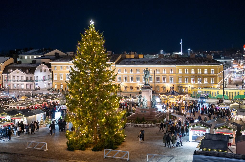 View of Christmas market and tree in Helsinki from Helsinki Cathedral on December evening