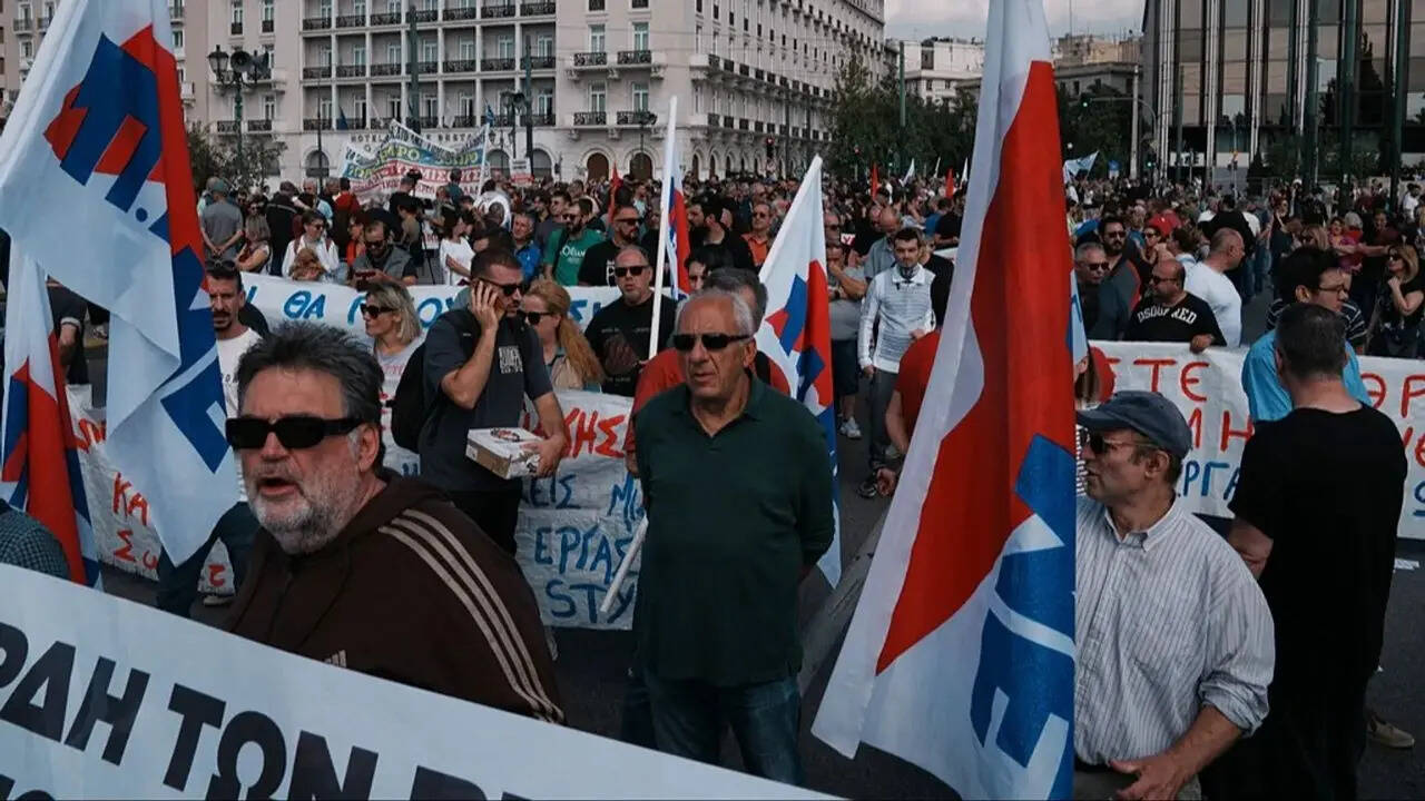 Greek workers march in Athens during a nationwide strike against the new 13-hour workday law. Greek workers march in Athens during a nationwide strike against the new 13-hour workday law.