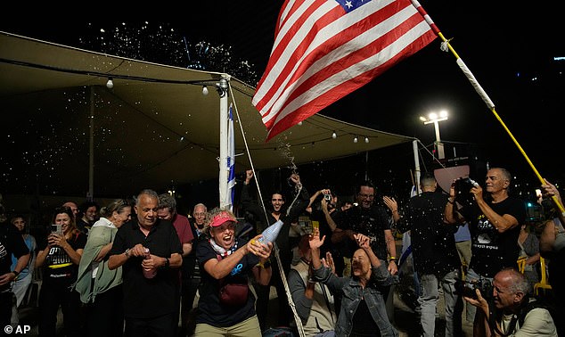Relatives and supporters of Israeli hostages held by Hamas in the Gaza Strip celebrate after the announcement that Israel and Hamas have agreed to the first phase of a peace plan, as they gather at a plaza known as the hostages square in Tel Aviv, Israel, Thursday, Oct. 9, 2025. (AP Photo/Ohad Zwigenberg)