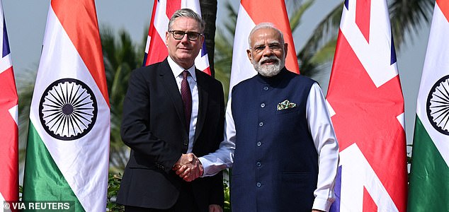 MUMBAI, INDIA - OCTOBER 9:  British Prime Minister Keir Starmer is greeted by Prime Minister of India Narendra Modi, on his arrival at Raj Bhavan on October 9, 2025 in Mumbai, India. Leon Neal/Pool via REUTERS