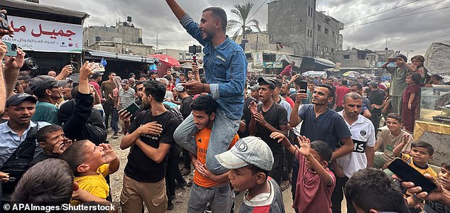 Mandatory Credit: Photo by APAImages/Shutterstock (15525251d) Displaced Palestinians celebrate in Khan Yunis on October 9, 2025, following news of a new Gaza ceasefire deal. Israel and Hamas on October 9 agreed a Gaza ceasefire deal to free the remaining living hostages, in a major step towards ending a war that has killed tens of thousands of people and unleashed a humanitarian catastrophe. Photo by Tamer Ibrahim\\ APA Images Displaced Palestinians celebrate in Khan Yunis on October 9, 2025, following news of a new Gaza ceasefire deal, Khan Yunis, Gaza Strip, Palestinian Territory - 09 Oct 2025