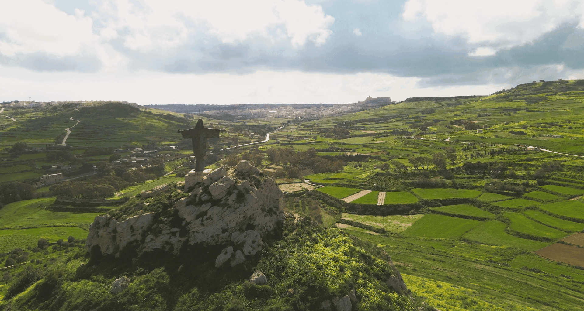 This is not Christo Redentor in Brazil, but Tas-Salvatur in Gozo, Malta, Europe. It dates back to 1901, 30 years earlier than the famous Rio the Janeiro statue. The statue was originally made of wood, but lasted only 3 years, and a stone successor was also replaced in the 1970s.