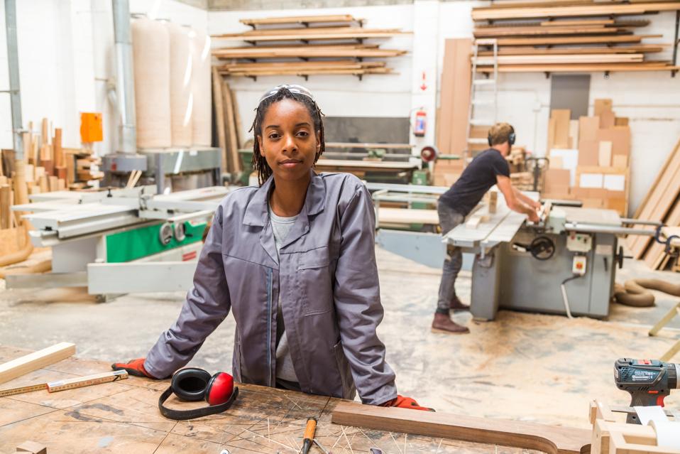 Portrait of young black female worker in a furniture factory