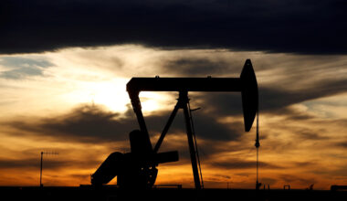 The sun sets behind a crude oil pump jack on a drill pad in the Permian Basin in Loving County