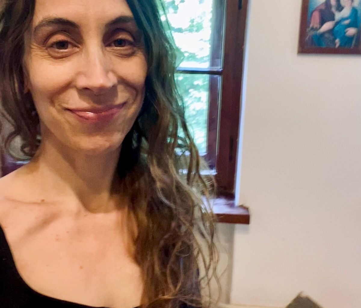 a woman soft smiling at camera