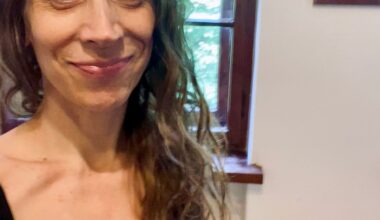 a woman soft smiling at camera