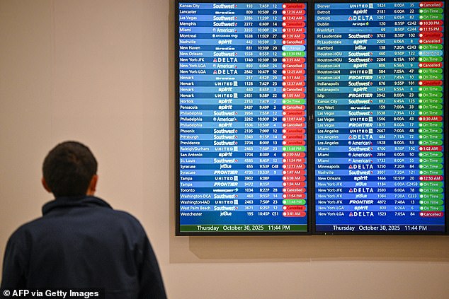 Cancelled flights are seen on a screen at Orlando International Airport in Orlando, Florida on October 30, 2025. Flights at Orlando International Airport faced major delays on October 30, after the Federal Aviation Administration (FAA) said the airport had no certified air-traffic controllers in its tower, forcing arrivals to be halted or severely delayed amid the ongoing US government shutdown. Air traffic controllers -- seen as "essential" public servants -- are kept at work during government shutdowns, but higher numbers are calling in sick rather than toiling without pay, leading to shortages. (Photo by Miguel J. Rodriguez Carrillo / AFP) (Photo by MIGUEL J. RODRIGUEZ CARRILLO/AFP via Getty Images)