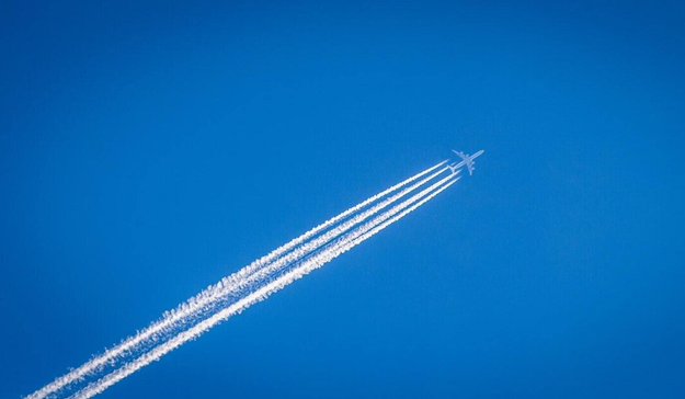 Contrails are lines of condensing water vapour and ice particles that form behind aeroplanes flying at high altitude, depending on atmospheric conditions. They are not "chemtrails".