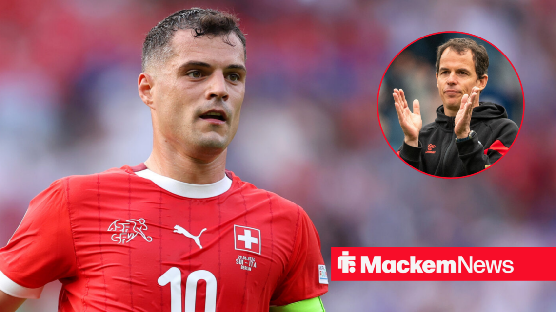 Granit Xhaka playing for Switzerland with Regis Le Bris applauding in frame