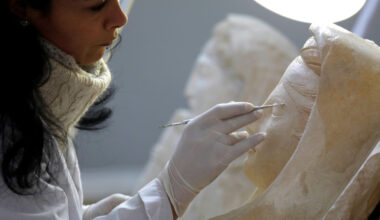 A specialist works on a damaged statue from Palmyra at Syria's National Museum of Damascus