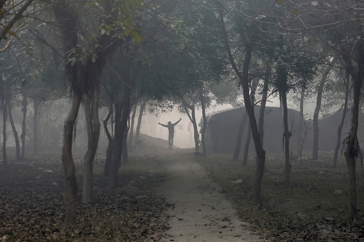 Dust and smoke covers the air along a riverbank in New Delhi. (Photo by Reuters)