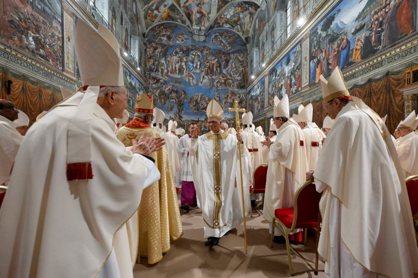 Pope Leo XIV walks in the Sistine Chapel at the Vatican on May 9, a day after his election as pontiff.