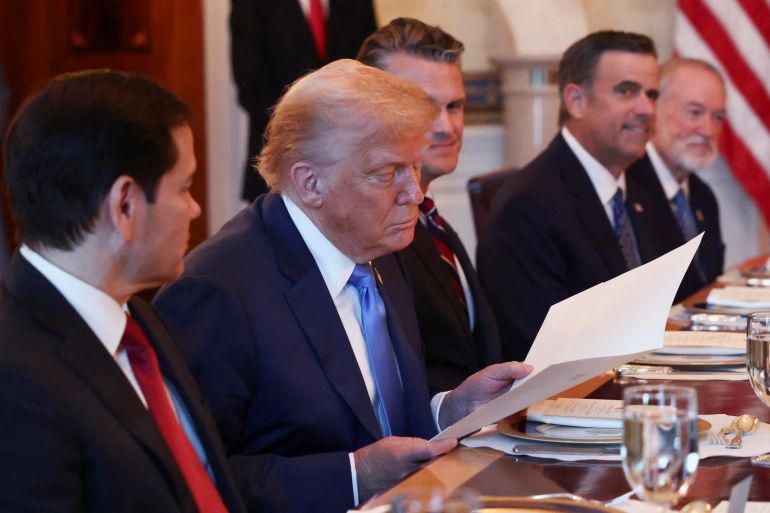 people sit at a dinner table with flags