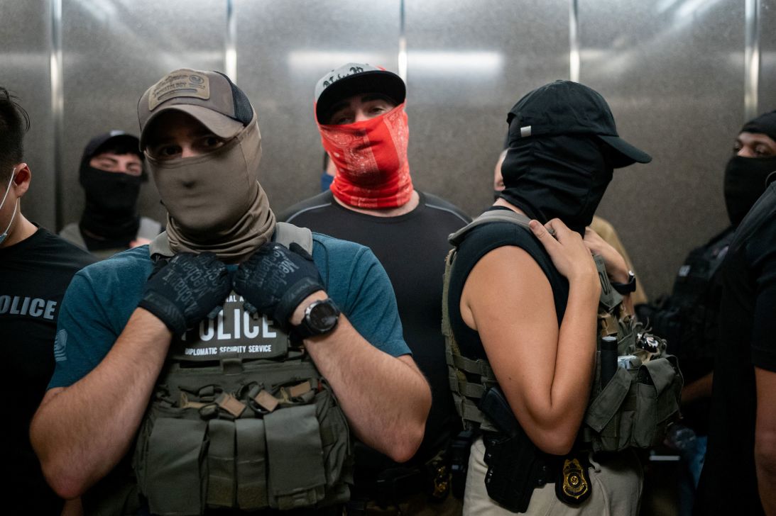 Federal immigration officers take the elevator at a US immigration court in New York on July 17.