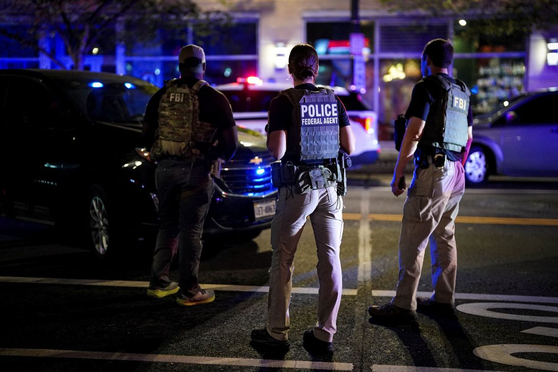 Members of the Federal Bureau of Investigation and federal law enforcement officers look on during a traffic stop in Washington, DC, on August 17.