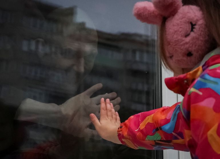 Freed Ukrainian prisoner of war (POW) Andrii Shemeyko, 39, looks out from a window at his daughter Nastya, 5, after a swap, amid Russia's attack on Ukraine, in an undisclosed location in Ukraine October 2, 2025. REUTERS/Anatolii Stepanov TPX IMAGES OF THE DAY