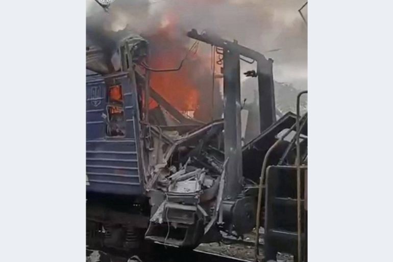A train burns after being hit by the Russian drone strike, amid Russia's attack on Ukraine,