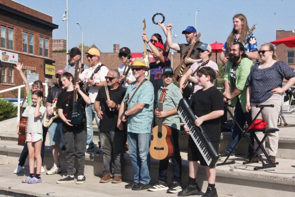 Local musicians rock downtown by Takin' Care of Business