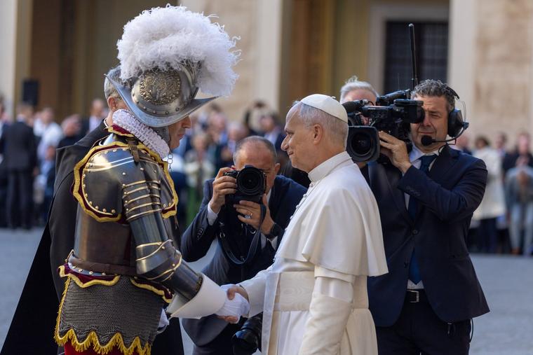 On the Feast of St. Francis of Assisi, 27 new Swiss Guards took their oath of allegiance in the presence of Pope Leo XIV, shown greeting a Swiss Guard. This marks the first time a pope has participated in the ceremony since Pope Paul VI in 1968.