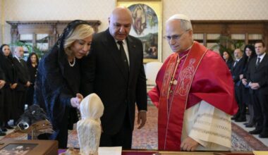 Pope Leo XIV speaks with Lebanese President Joseph Aoun and his wife, Nehmat, in the library of the Apostolic Palace at the Vatican June 13, 2025.