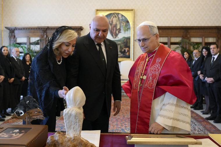 Pope Leo XIV speaks with Lebanese President Joseph Aoun and his wife, Nehmat, in the library of the Apostolic Palace at the Vatican June 13, 2025.