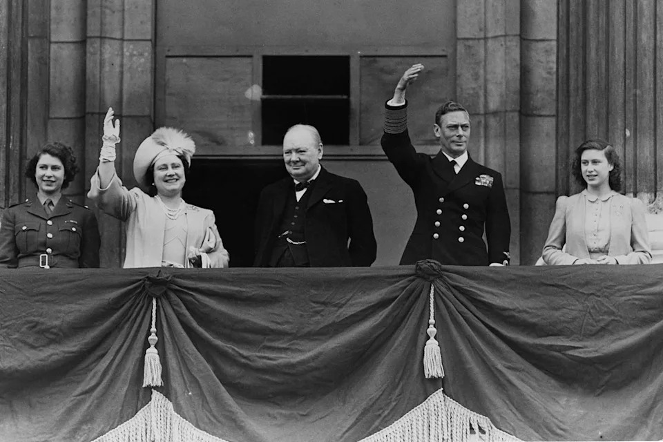 Reg Speller/Getty British Prime Minister Winston Churchill (center) on the Buckingham Palace at VE Day which marked the end of the Second World War