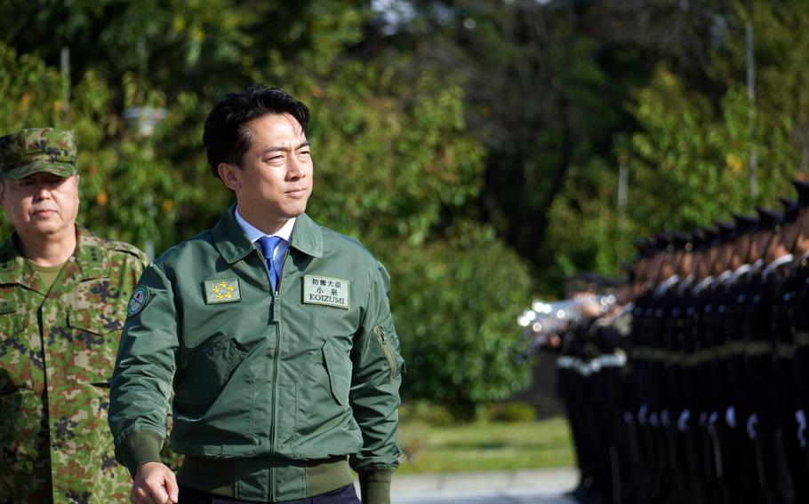 Japan's newly sworn-in defense minister, Shinjiro Koizumi, inspects the Ground Self-Defense Force honor guard at Camp Asaka in Tokyo, Oct. 23, 2025.