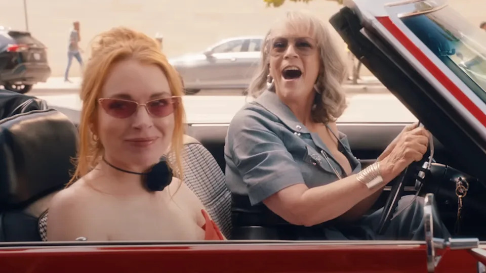 Lindsay Lohan and Jamie Lee Curtis in a convertible with sunglasses on in Freakier Friday.