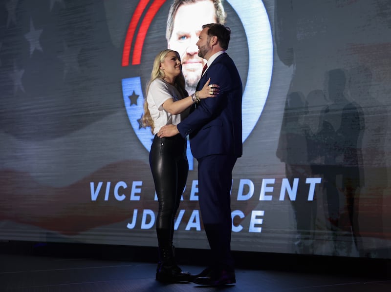 Erika Kirk, widow of Turning Point USA founder Charlie Kirk, and U.S. Vice President JD Vance embrace on stage during a Turning Point USA event