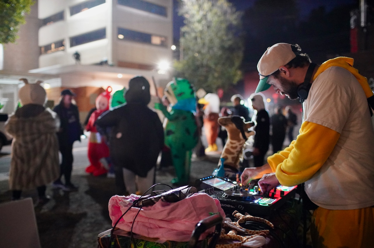 A DJ plays music outside the ICE facility