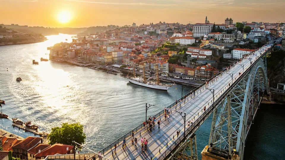 View of Porto city and Douro river and Dom Luis bridge I from famous tourist viewpoint Miradouro da Serra do Pilar on sunset. Porto, Vila Nova de Gaia, Portugal