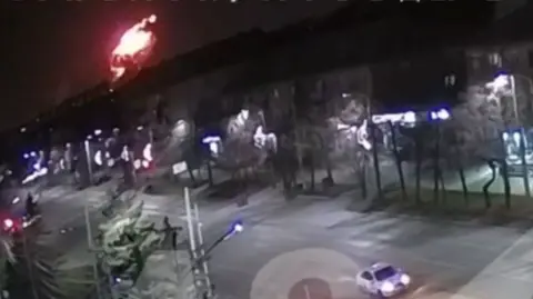 Astra/Telegram A fireball pictured in the corner of a screen while a car drives along a street