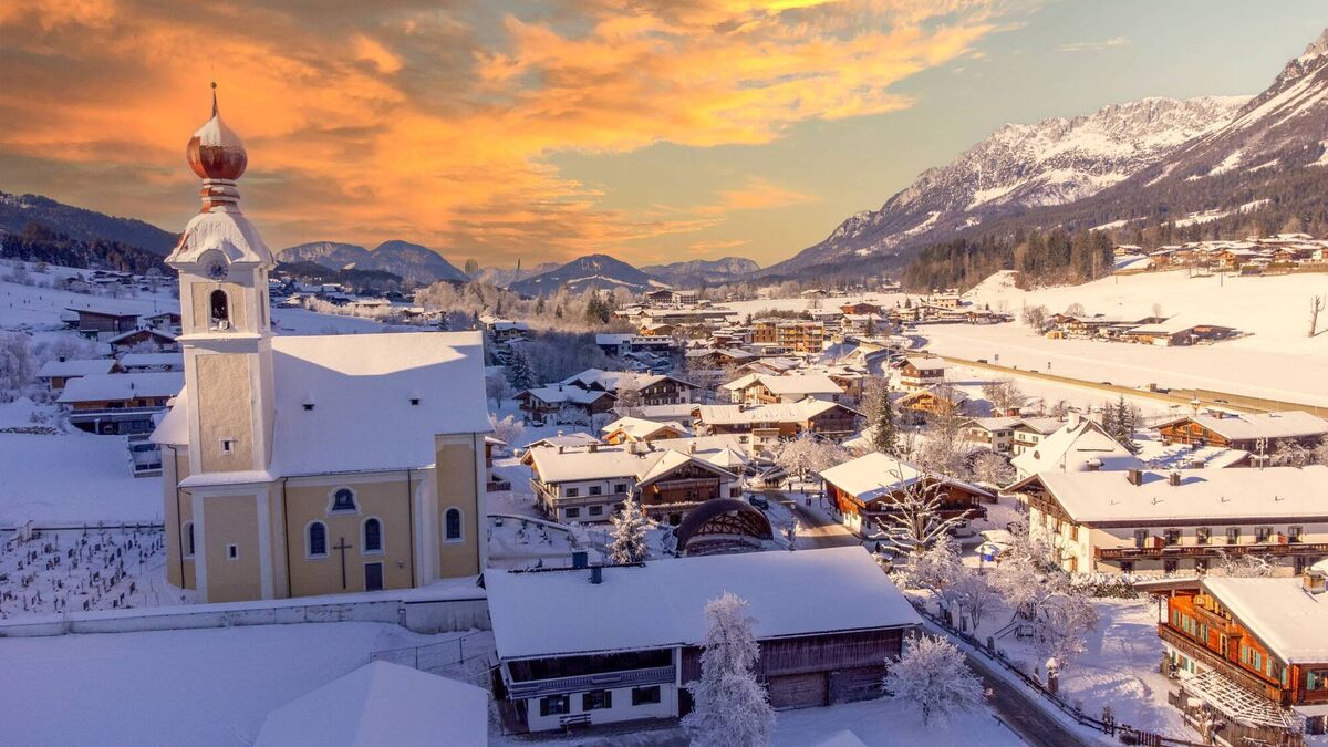 View of the the Alps and village church at Wilder Kaiser in Austria  View of the the Alps and village church at Wilder Kaiser in Austria