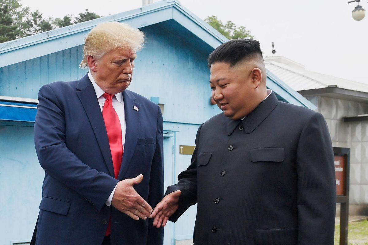 U.S. President Donald Trump, left, shakes hands with North Korean leader Kim Jong-un at the border village of Panmunjeom in the Demilitarized Zone between the two Koreas, June 30, 2019. AP-Yonhap
