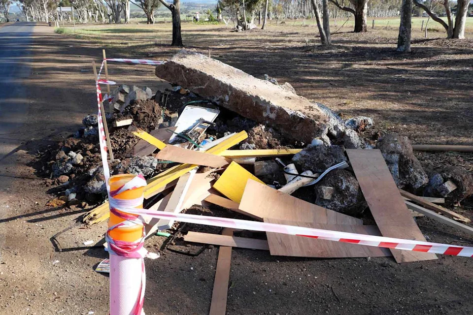 A close up of the concrete, wood and rubble dumped on the road. 