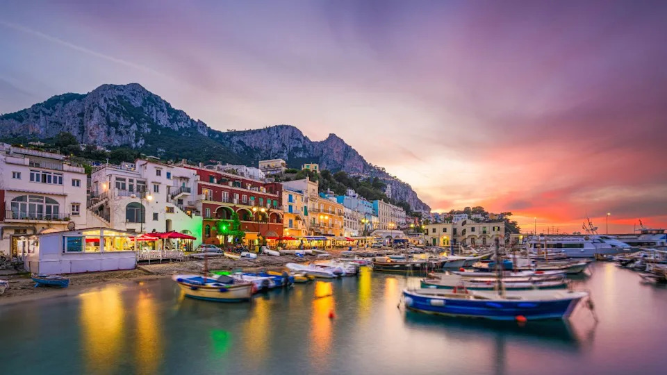 Capri, Italy with shops and restaurants at at Marina Grande at twilight.